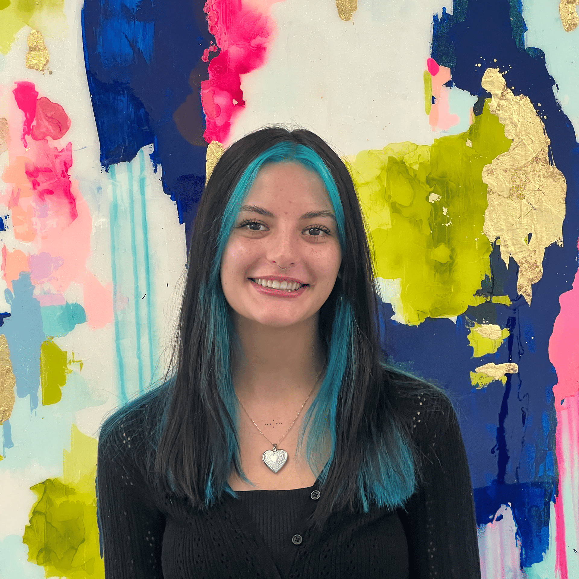 Portrait of Riley, a professional stylist at Pura Vida Salon, showcasing their expertise and style.